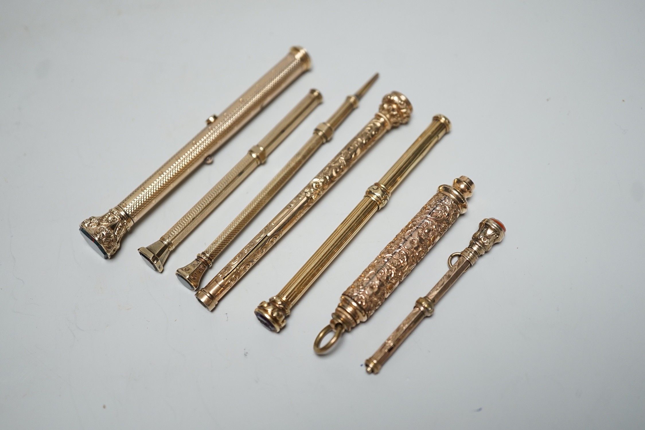 Seven assorted yellow metal overlaid and gem set propelling pencils